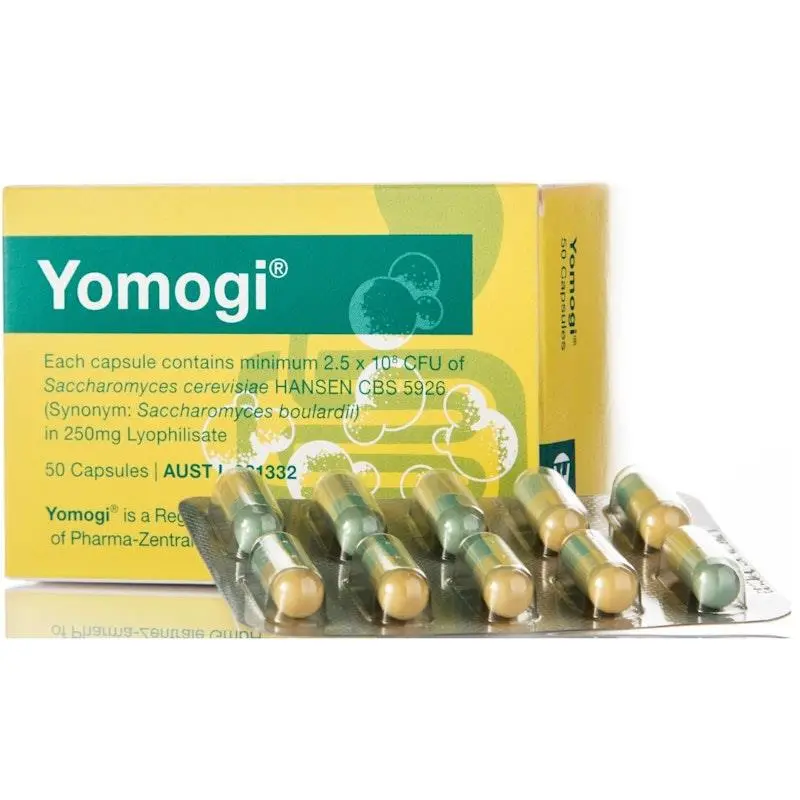 Box of Yomogi probiotic capsules with green and beige capsules visible in blister pack in front of the packaging.