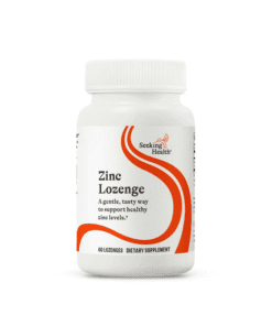 White plastic bottle of Seeking Health Zinc Lozenge dietary supplement with orange curved design and black text.