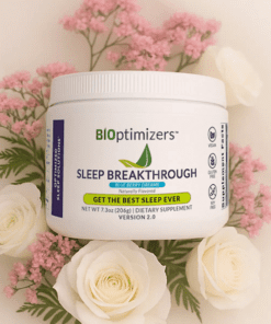 BiOptimizers Sleep Breakthrough dietary supplement container surrounded by white and pink flowers.