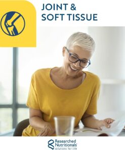 Smiling woman in yellow shirt reading a document at a table with a stack of pancakes and a glass, with knee joint graphic and joint and soft tissue text.